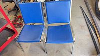 Front view of both blue vinyl chairs side by side
