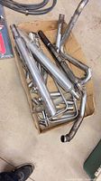 Box of assorted chrome motorcycle exhaust parts