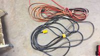 Two groups of coiled extension cords on floor