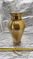 full view of hammered brass vase front