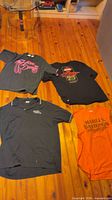 Four Harley-Davidson tops laid out showing overall condition and colors
