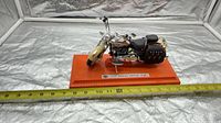 Full side view of FLSTS Heritage Springer model on base with measuring tape