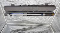 Torque wrench in open storage case