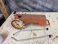 sprinkler base, hose inlet, wheels, two spray arms detached