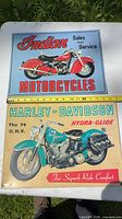 Front view of both tin signs showing graphics and colors