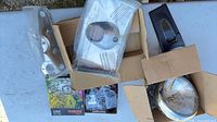 Group of parts including headlight, rectangular lens, gasket kit, brackets, hardware