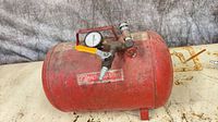 Full view of red Motomaster steel air tank with gauge, valve, and quick-connect
