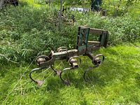 Overall view of mounted cultivator showing frame and tines