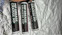 Front view of three cartridges showing MP Grease labeling and quantity