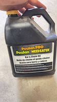 Front of Poulan PRO bar & chain oil jug
