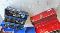 Open blue Old Pal organizer showing compartments with hardware beside open red toolbox