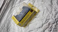 Front view of sealed Sony DualShock 2 controller in packaging