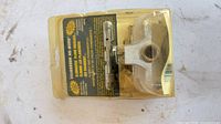 Front view of sealed Squeeeeek No More kit showing bracket and label.