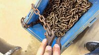 Blue bin containing two steel link chains with hooks