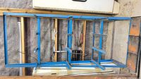Full view of blue steel rack lying on its side showing overall structure