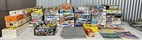 Wide shot of full lot showing stacked model kit boxes, paint spray tool and books