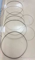 Six of the coiled bandsaw blades laid flat to show diameters