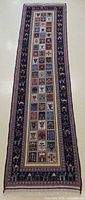 Full view of wool runner rug showing geometric panel field and camel border