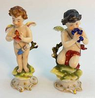 Front view of both cherub figurines on gilded bases