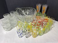 Group shot of punch bowl, ladle, punch cups, juice glasses, pilsner glasses