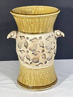 Front view of vase showing bird heads and carved bird motif