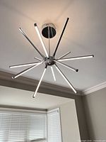 Chandelier view from below showing 12 LED arms and chrome finish