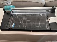 Top view showing full trimmer, grid and teal blade carriage