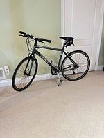 Full side view of Trek FX hybrid bicycle showing frame, wheels, handlebars, saddle bag, kickstand