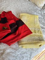 Red and yellow blankets folded on bed