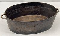 Full view of oval cast iron pot with handles showing size and condition