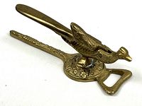 side view showing full brass bird nutcracker and bottle opener