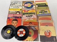 Grid of 45 rpm singles with sleeves and loose discs
