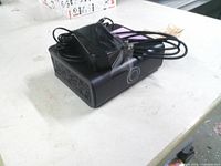 Top and side view of external hard drive with power adapter and cables on top