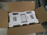 Open box showing internal Styrofoam packaging for speaker set