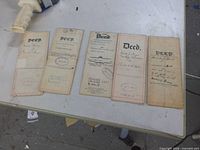 Fronts of five folded deed documents showing titles and stamps