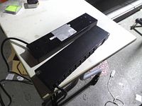 Both APC Metered Rack PDUs stacked on table