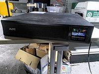Front view showing APC logo and LCD with battery warning