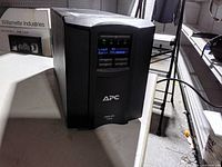 Front view of APC Smart-UPS 1000 showing LCD display and brand logo