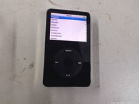 Front view of powered-on Apple iPod Classic showing menu on screen