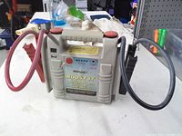 Front view showing Boost It branding, control panel and attached booster cables