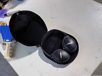Open carrying case showing Bose headphones inside