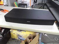 Front and top view of Bose Solo TV sound system showing enclosure and grille
