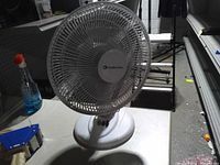 Front view of white Comfort Zone oscillating desk fan showing grille and control buttons