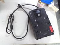 Top view showing CyberPower logo, power button, eight outlets, 600VA marking, attached cord