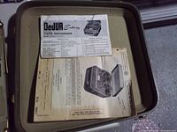Manuals and paperwork inside carrying case lid
