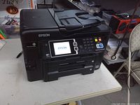 Front view of Epson WF-3640 printer powered on showing touchscreen display and ADF