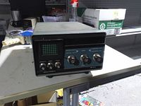 Front view showing CRT screen, controls and branding