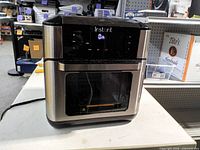 Front view of Instant air fryer oven powered on