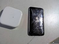 Back of iPod touch showing 16GB marking beside power adapter