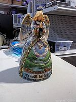 Front view of Jim Shore Heartwood Creek Peaceful Journey angel figurine showing landscape scene and inscription